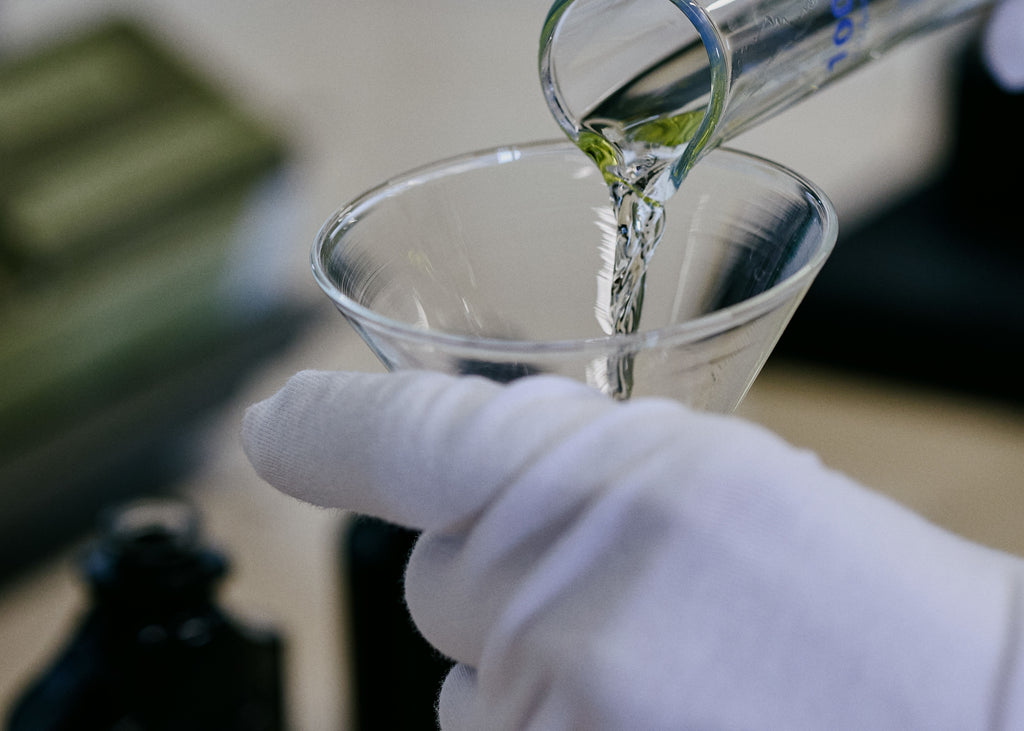 Pouring the fragrance oil into graduated cylinger