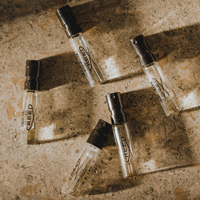 Complimentary Samples Five Creed sample perfume on a marbled surface